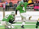 Paul McCallum of the Roughriders, holding Keith Smith, kicks a CFL record 62 yards field goal October 27, 2025 at Taylor Field against Edmonton.
