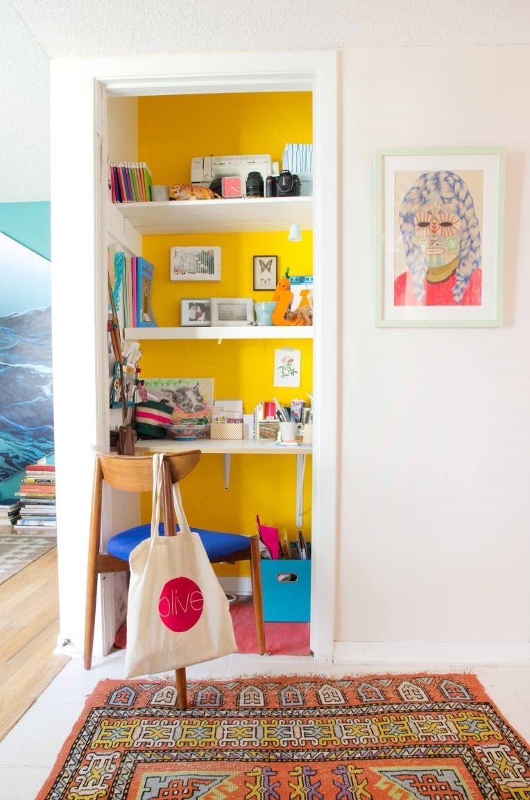 A picture of a small closet converted into a desk.